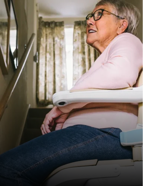 Woman sitting comfortably on a straight stair lift